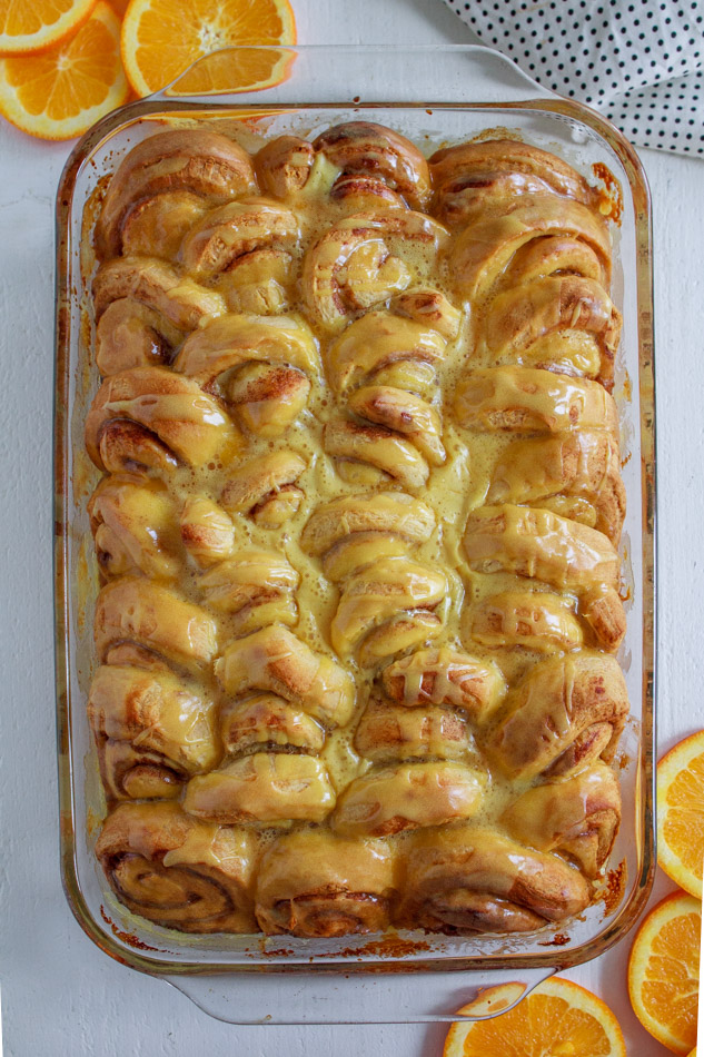Easy Orange Sweet Rolls are just as easy as boiling water.  Yes, these are semi-homemade so you don't have to worry if you don't know how to make bread from scratch.  It's the extra steps of adding cream, brown sugar and orange zest to the bottom of the pan that creates these ooey-gooey Orange Rolls.  