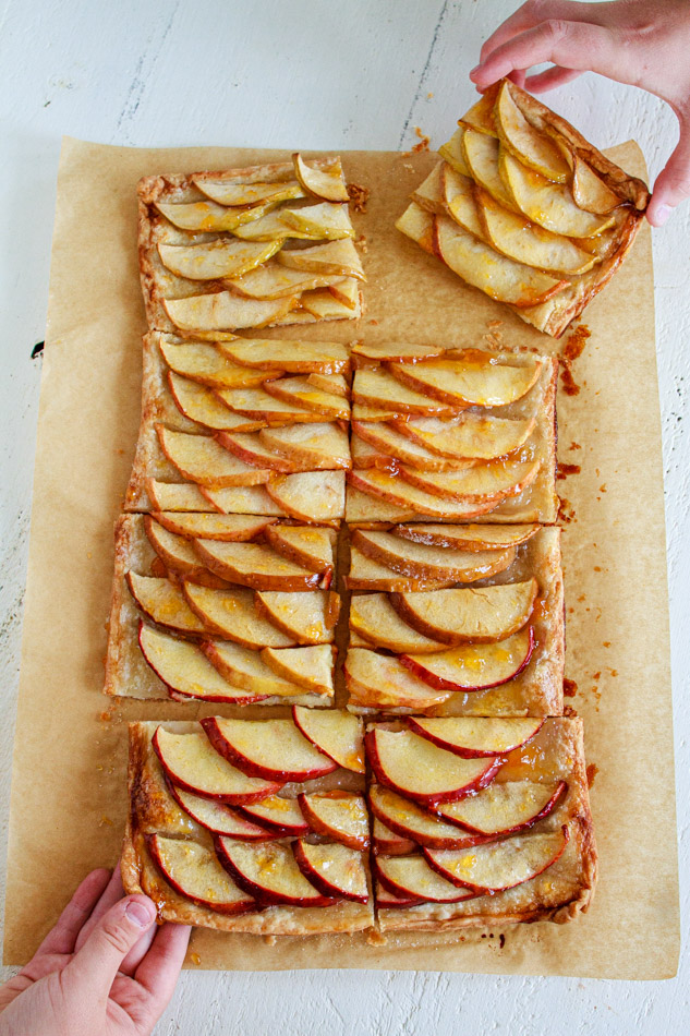 This Apple Tart is super simple to make!  Arrange an ombre array of apples, darkest to lightest, on a homemade pasty dough and baked to perfection.  Sweet and tart all on a flaky crust!  No pie plate is needed.  Super simple recipe and perfect for the holidays!