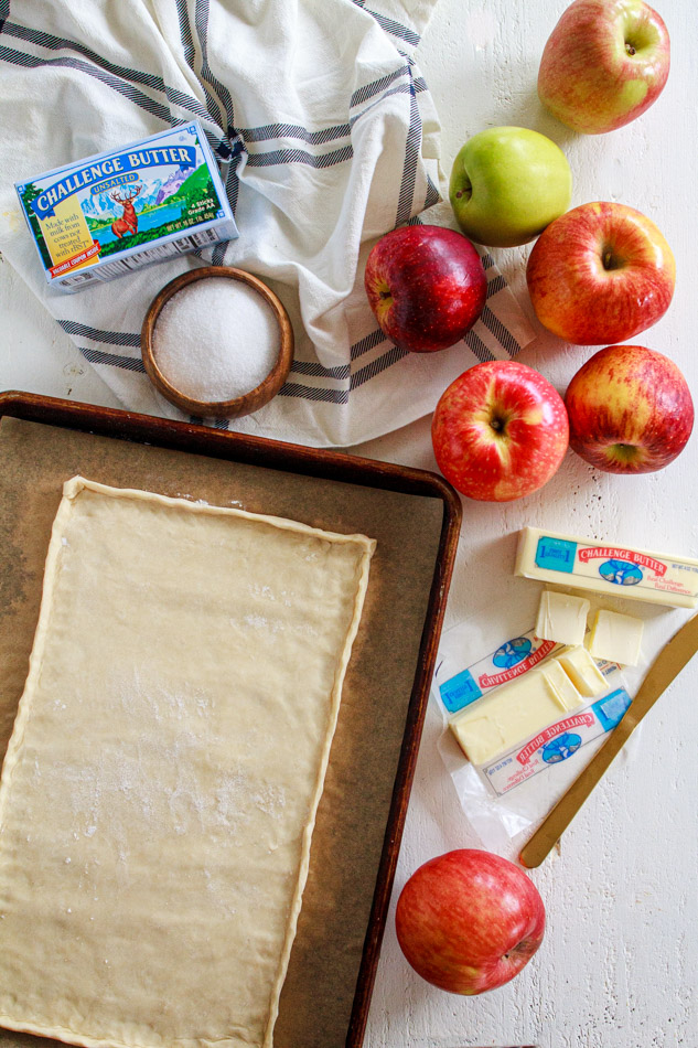 This Apple Tart is super simple to make!  Arrange an ombre array of apples, darkest to lightest, on a homemade pasty dough and baked to perfection.  Sweet and tart all on a flaky crust!  No pie plate is needed.  Super simple recipe and perfect for the holidays!